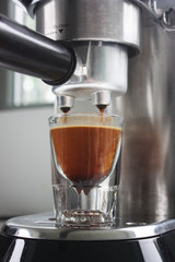 Espresso being poured into an espresso shot glass
