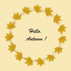 Round frame from autumn leaves. Yellow maple leaves on a beige background. There is text 