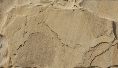 Background stone sandstone, processed by sea waves and rain.