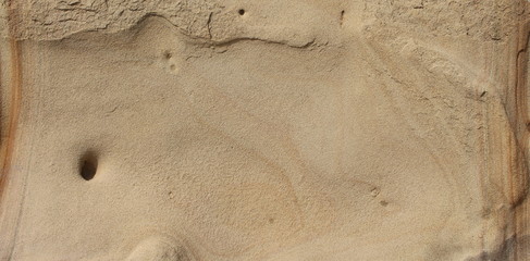 Background stone sandstone, processed by sea waves and rain.