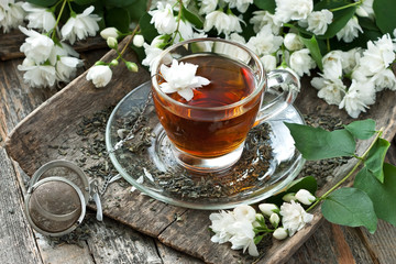 Cup of jasmine tea and jasmine flowers