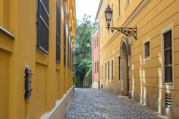 Fototapeta na wymiar small european empty street urban city scape concept with wall lantern in summer time bright day 