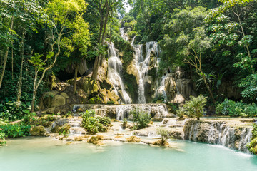 Tad Kwang Si (Xi) the biggest water fall land mark in Luang Prabang, Laos ,beautiful turquoise color water at tropical forest in north Lao, for use as a background or travel advertisement image