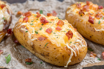 Baked loaded potato with bacon, cheese and onion