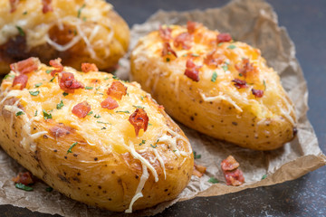 Baked loaded potato with bacon, cheese and onion