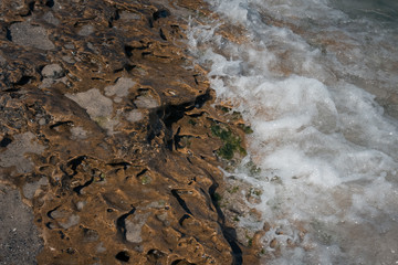 stone texture on the beach with water;