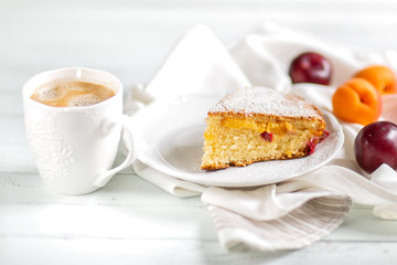 Homemade cake.Food preparation.fruit sweet cake with apricots and plums. Served table With coffee and cake. Kitchen items