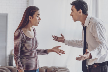 Family conflict. Unhappy young people looking at each other while fighting