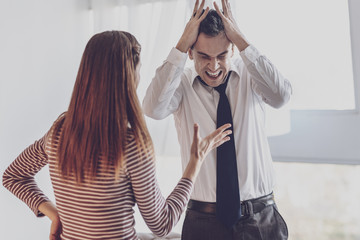 Stop talking. Angry emotional man covering his ears while having a nervous breakdown