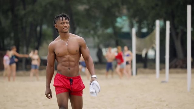 Sexy macho man on a beach hello greeting salute gesture