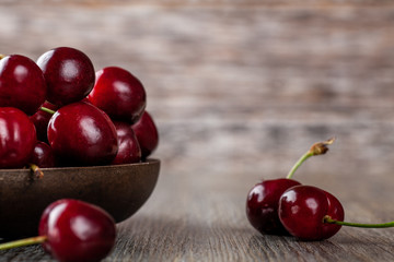 Fresh Ripe Cherries in a rustic wooden bowl