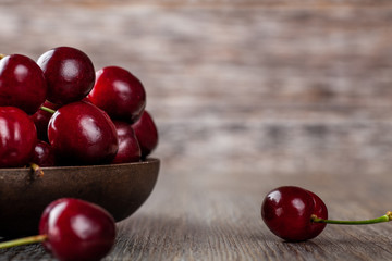 Fresh Ripe Cherries in a rustic wooden bowl