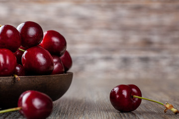 Fresh Ripe Cherries in a rustic wooden bowl
