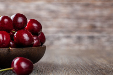 Fresh Ripe Cherries in a rustic wooden bowl