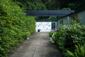 Back yard of the house in the form of an avenue, with plants and flowers, Germany, Hamburg.