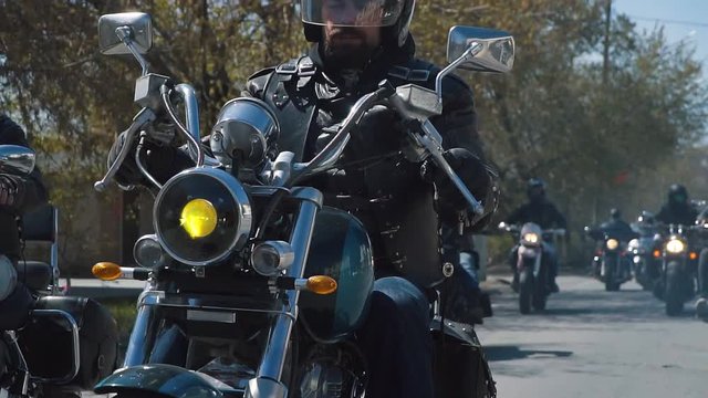 many subculture bikers group ride on the track on a Sunny summer day on custom motorcycles, a large-scale action of motorcyclists