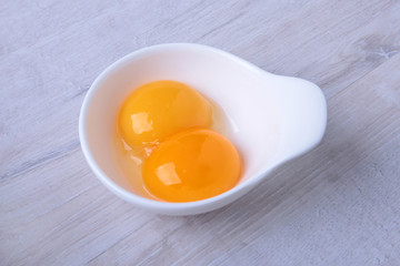 Egg yolk in bowl. ingredient for homemade tiramisu cake in close up.