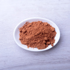 Cocoa powder in bowl. ingredient for homemade tiramisu cake in close up.