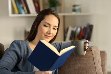 Woman reading a book relaxing at home