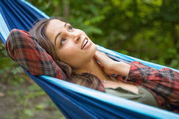 Portrait of Attractive Hispanic Young Adult Girl In Hammock Outdoors
