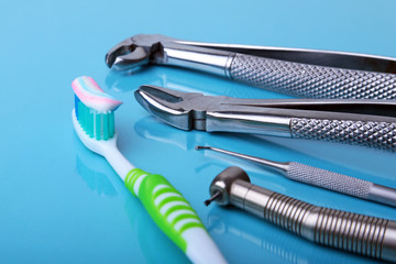 dental care toothbrush with dentist tools on mirror background