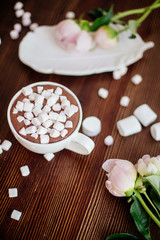 Fototapeta na wymiar Cocoa with marshmallow and flowers.