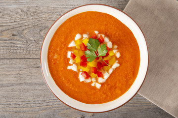 Soup gazpacho. Italian cuisine. Plate with soup in a white plate on a rustic background. Top View. Copyspace.