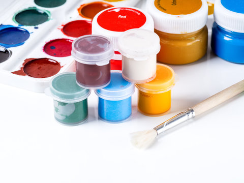 Paints and brushes on a white background