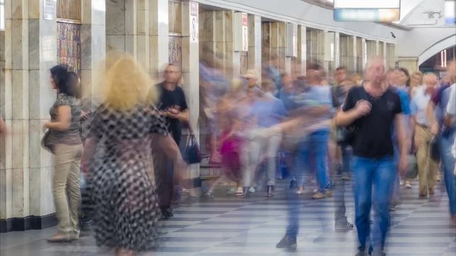 Crowd of blurry people in the subway at rush hour. Time lapse. Zoom effect
