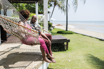 Couple talking and sitting on a hammock