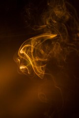 Gold smoke on black background.