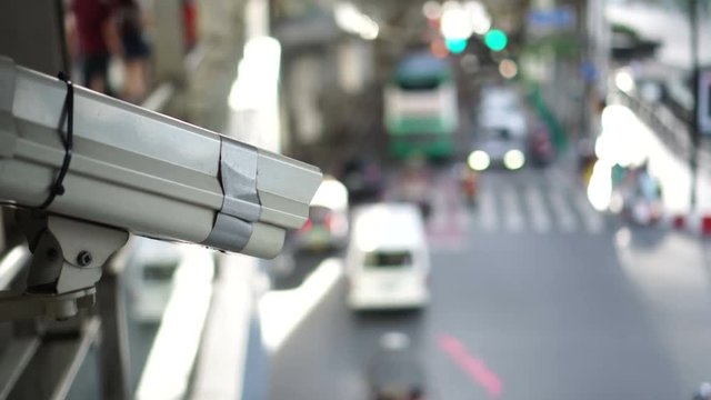 City cctv surveillance over street, people and public traffic video 4k