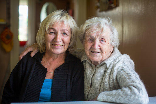 An Elderly Woman With Her Adult Daughter.