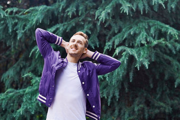 Man in the forest against green tree background