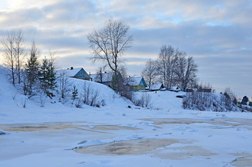 Wooden houses on the banks of the river Onega. Russia