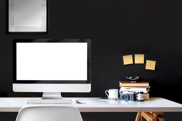 Minimal artist loft workspace with mockup desktop computer and poster.