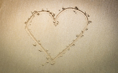 Top view of Heart on sand of the beach.