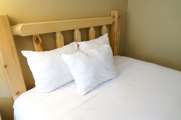 close up on pillows on wood bed