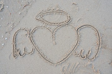 Drawing of a Heart on a Sand Beach. Sand texture abstract background. Sandy beach for background. Top view. space for your text.