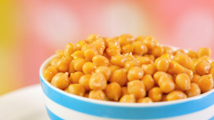 Chickpeas, garbanzo beans, healthy source of dietary fibre and protein, in bowl macro closeup with copy space.
