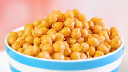Chickpeas, garbanzo beans, healthy source of dietary fibre and protein, in bowl macro closeup.