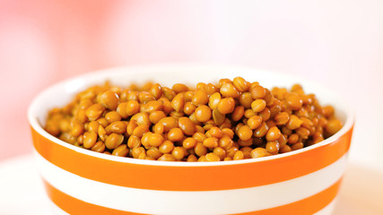 Lentil beans, healthy source of dietary fibre and protein, in bowl closeup with copy space.