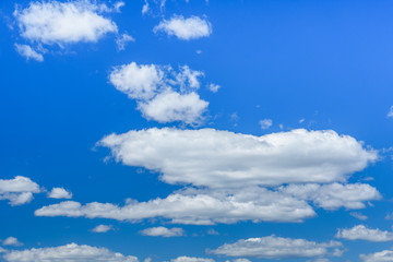White fluffy clouds in a deep blue sky