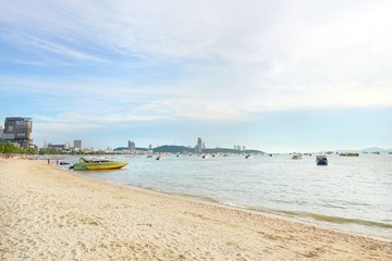 PATTAYA, THAILAND - MAY 19, 2018 : Speed boats anchored waiting for tourist at pattaya beach in the evening, People playing the sea. Many tourists visit here. View for seascape. Space for text in temp
