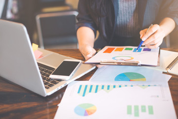 Businessman analysis working discussing the charts and graphs showing the results.