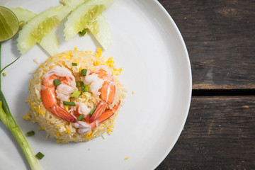 Fried rice with shrimp on the wooden table from top view