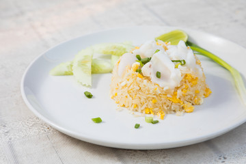 Fried rice with Squid on the wooden table from top view