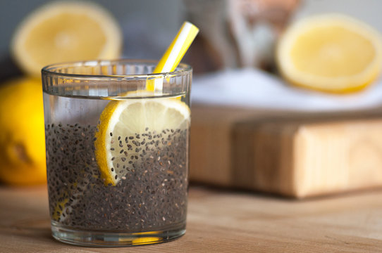 Superfood, chia in water with lemon on kitchen table. Side view. Summer cocktail, healthy food, soft drinks.