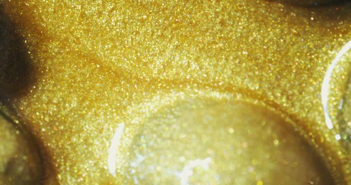 Coffee beans in gold oil.  gold oil paints. Macro. 4K.
