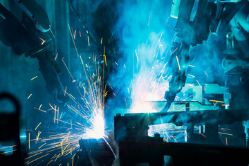 Industrial robots are welding merging in car factory